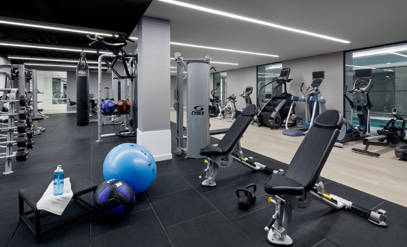 Fitness center featuring a plethora of equipment