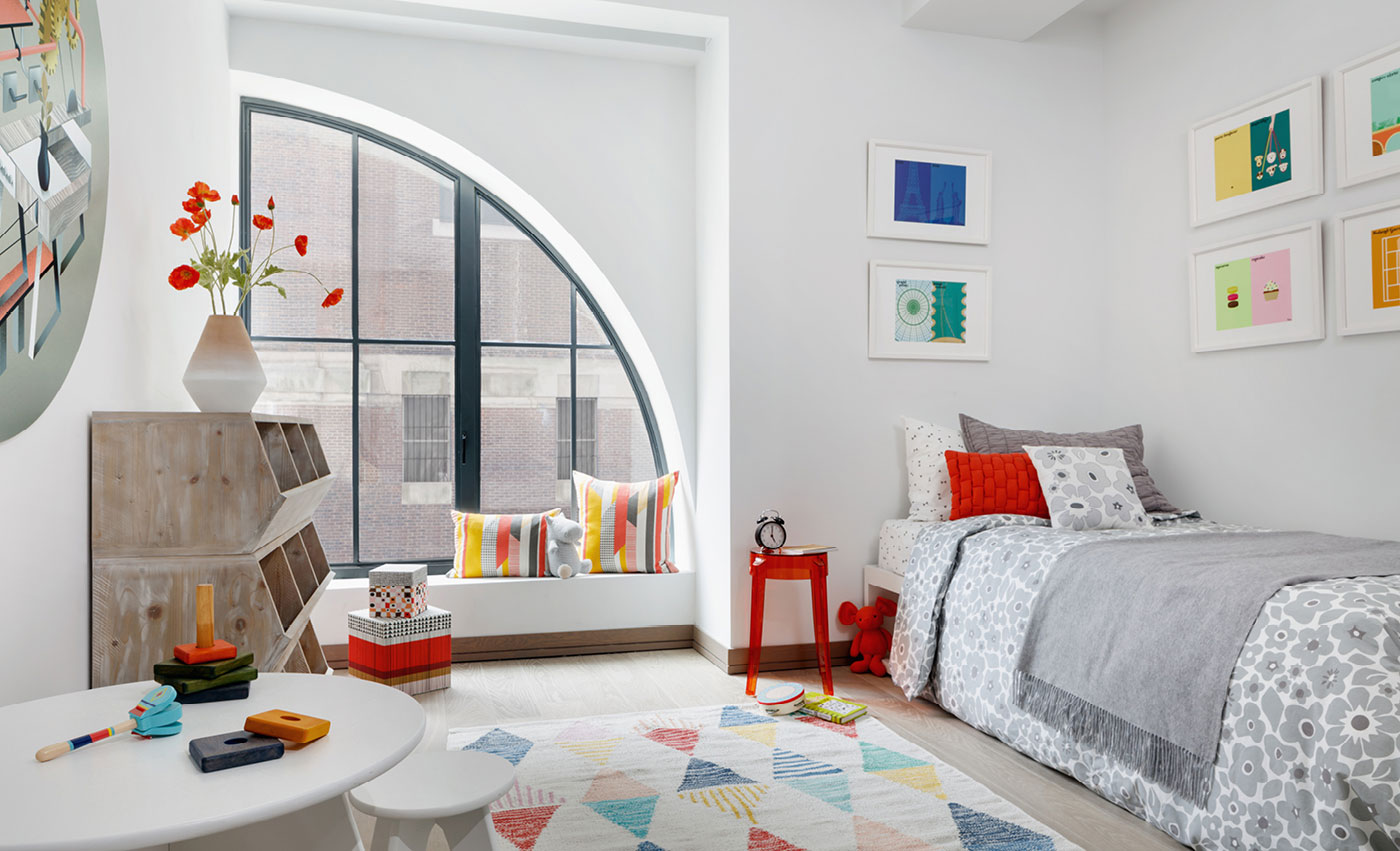 Children's bedroom with large window and colorful furniture