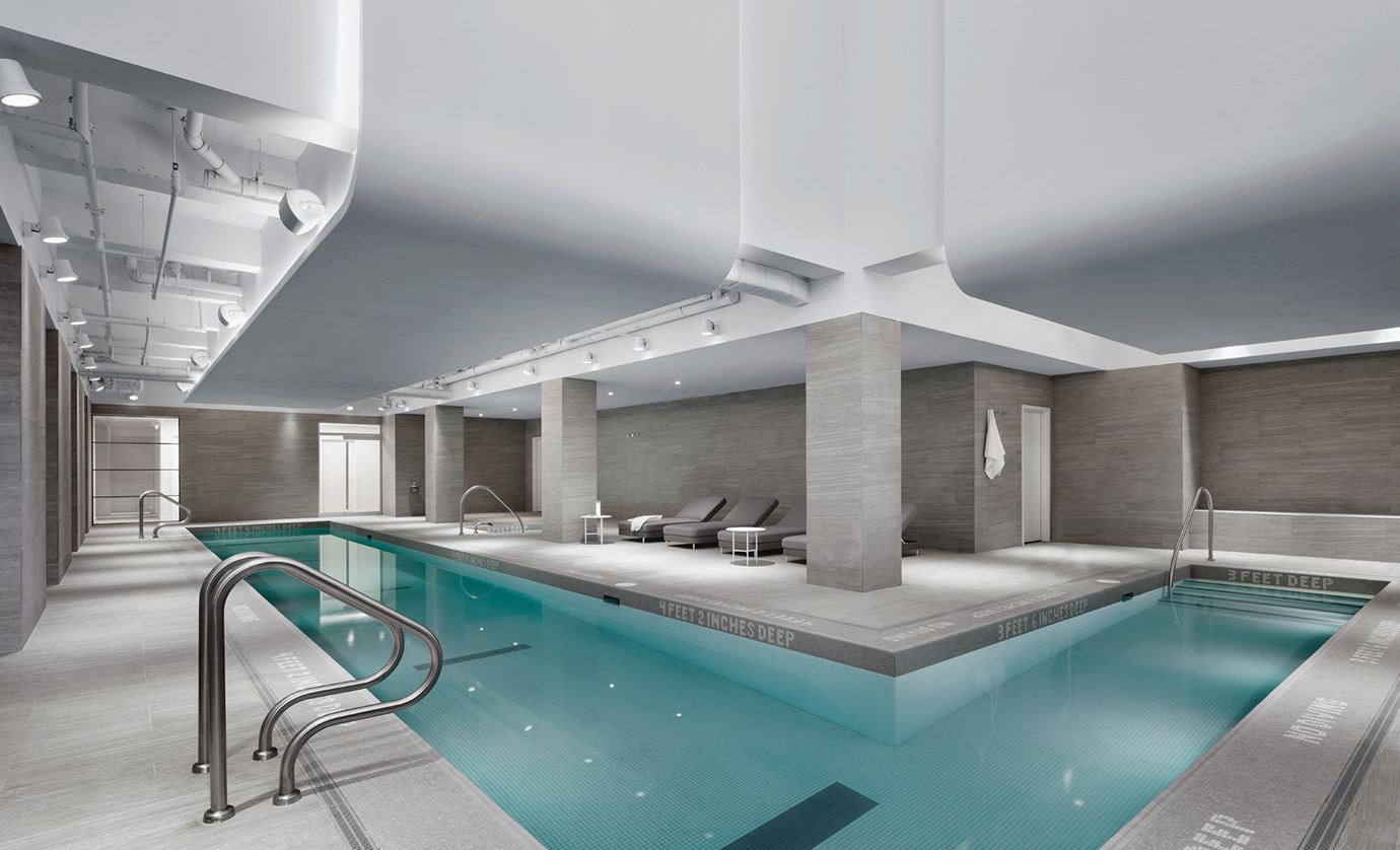 The pristine, sunlit atrium features a 60-foot, L-shaped pool, perfect for swimming laps or just a casual dip, as well as an adjacent hot tub for relaxation.