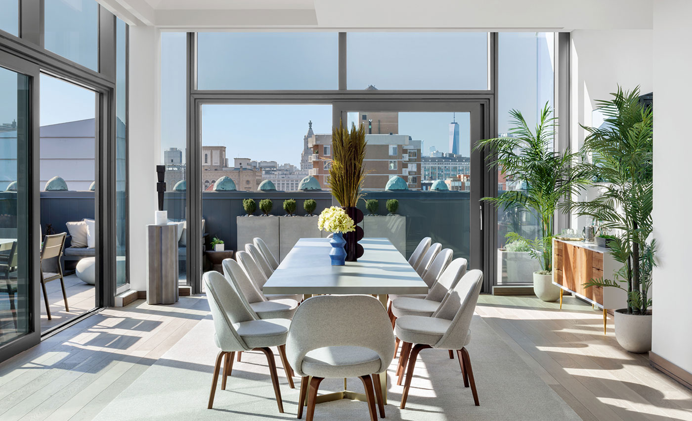Penthouse 1’s glass-enclosed dining room and wrap-around terrace