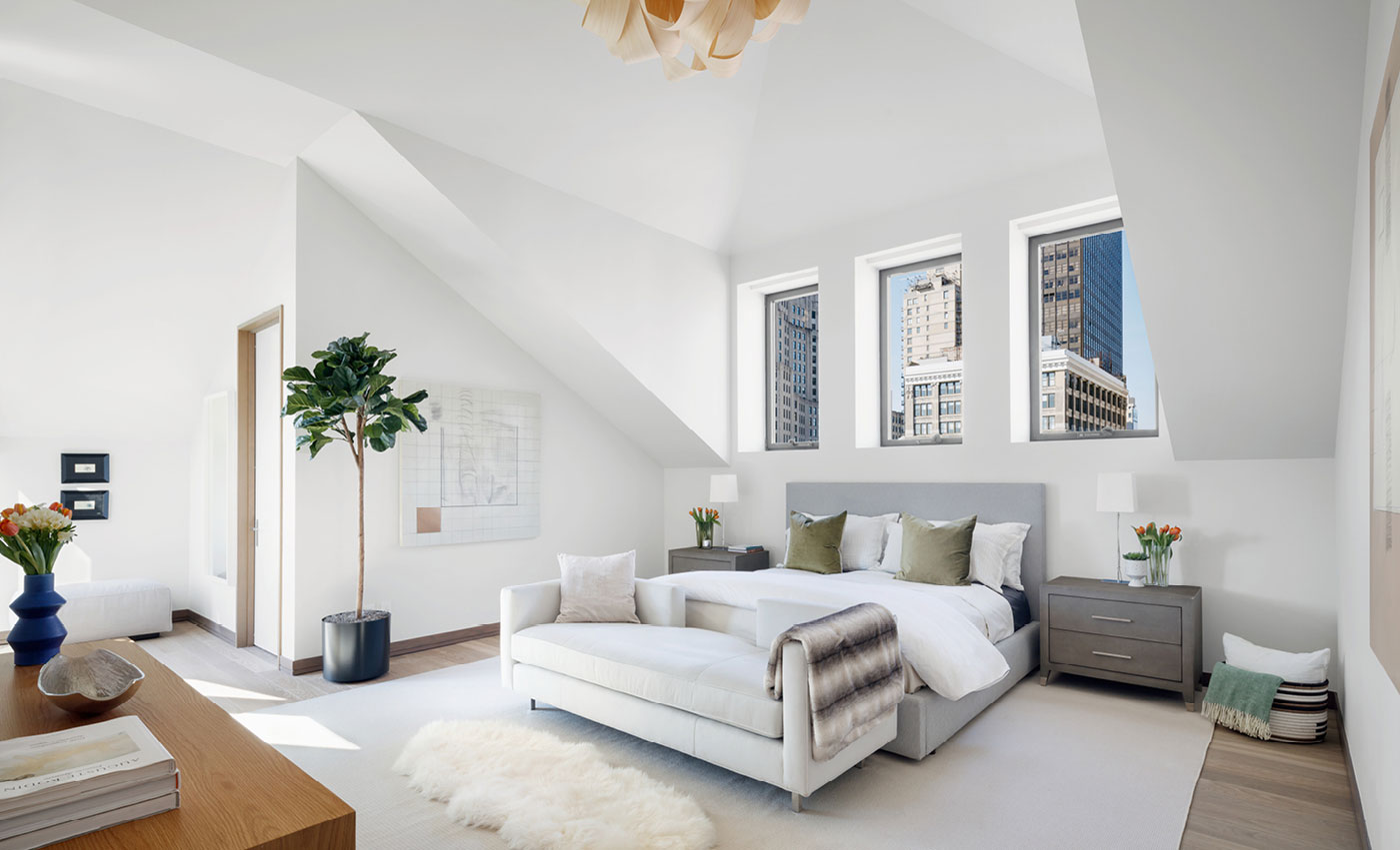 Penthouse 1’s master bedroom suite, with distinctive vaulted ceilings and direct terrace access